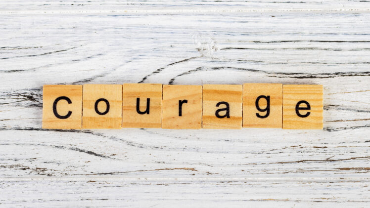photo of the word "courage" in word blocks.